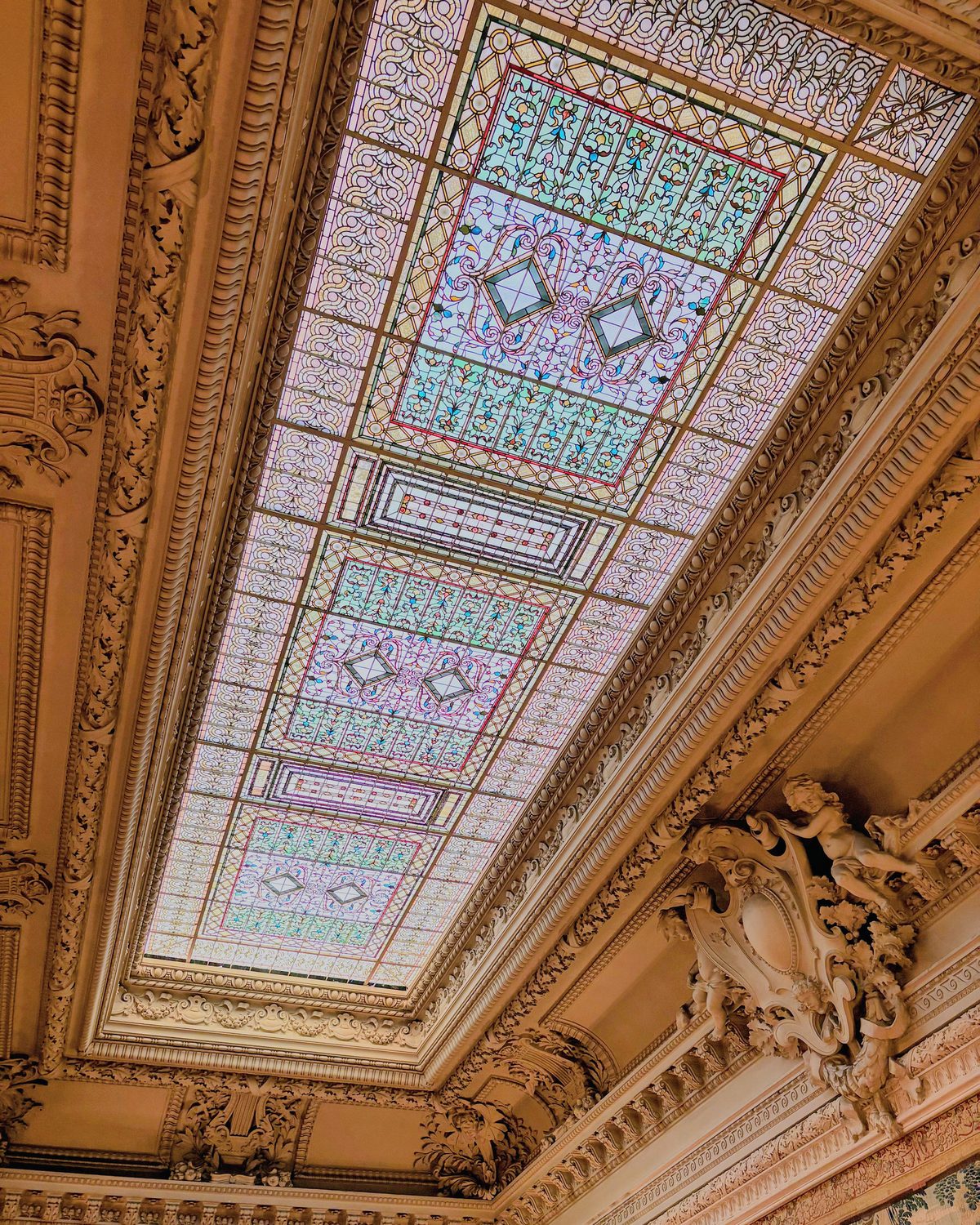 Stained glass ceiling panel set into carved gilt plasterwork